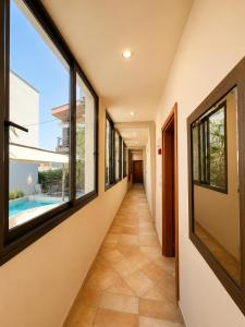 a hallway of a house with windows and a pool at Kladis Club Holidays in Skala Potamias +13 photos