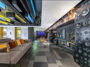 a living room with a couch and a checkered floor at CitiGO Hotel Shanghai Xujiahui in Shanghai