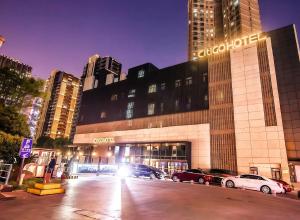 a large building with cars parked in front of it at CitiGO Hotel Shanghai Xujiahui in Shanghai