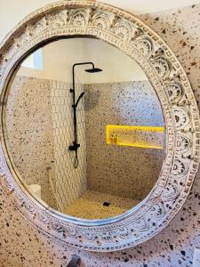 a mirror reflecting a shower in a bathroom at Umanara Ubud in Ubud +13 photos
