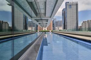 a swimming pool in a city with tall buildings at Millennium Hotel Taichung in Taichung