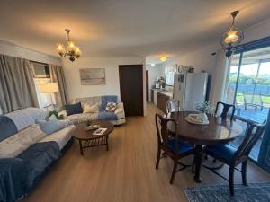 a living room with a table and a living room with a couch at Flahertys Retreat in Point Turton