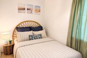 a small bedroom with a bed and a window at Flahertys Retreat in Point Turton
