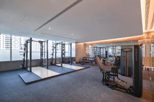 a gym with treadmills and cardio equipment in a building at Millennium Hotel Taichung in Taichung
