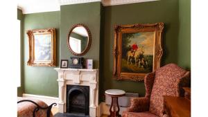 a living room with a painting of a man riding a horse at Governors Room in Cimarron