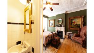 a bedroom with a bed and a fireplace and a sink at Governors Room in Cimarron