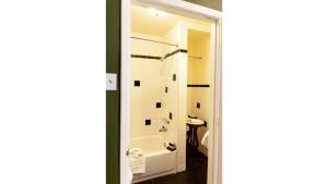 a bathroom with a bath tub and a sink at Governors Room in Cimarron