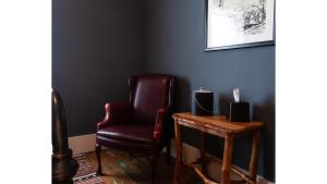 a living room with a red chair and a table at Fred Lambert in Cimarron