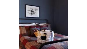 a dog sitting on a bed in a bedroom at Fred Lambert in Cimarron