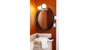 a bathroom with a sink and a mirror at Doc Holiday in Cimarron