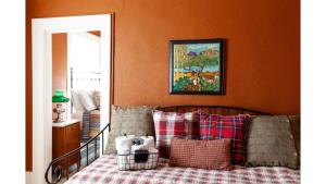 a bedroom with a bed with plaid pillows on it at Doc Holiday in Cimarron