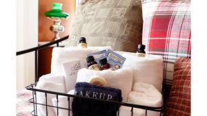a basket filled with towels and wine bottles on a couch at Doc Holiday in Cimarron +6 photos