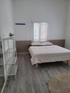 a bedroom with a bed and a book shelf at Serenity Apartment in Dalia in Dāliyat el Karmil