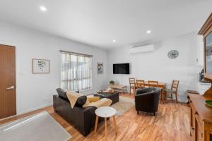 a living room with a couch and a table at 15B Bolton Street in Berridale