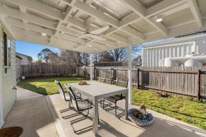 a patio with a white table and chairs at 15B Bolton Street in Berridale