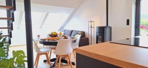 a kitchen and dining room with a table and chairs at La Terrasse d'Arthur et Manon in La-Roche-en-Ardenne