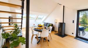 a kitchen and living room with a table and chairs at La Terrasse d'Arthur et Manon in La-Roche-en-Ardenne