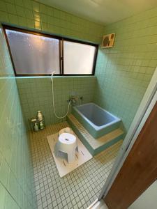 a bathroom with a toilet and a bath tub at Ohana in Kuroshio