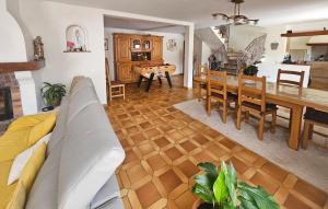a living room with a couch and a dining room at Nice Home In Peymeinade in Peymeinade