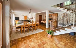 a dining room and kitchen with a table and a staircase at Nice Home In Peymeinade in Peymeinade