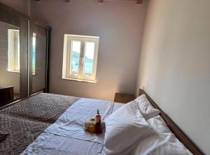 a bedroom with a bed with a bottle on it at Casa del Mar Rooms in Lopud