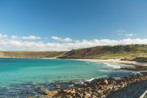 a view of a beach with rocks and the ocean at The Old Success Inn in Sennen Cove
