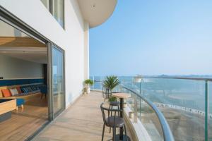 a balcony of a building with a table and chairs at Homestay Alacarte - Icon40 - New Life - Villa Lotus in Ha Long