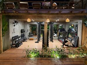 an indoor gym with treadmills and elliptical machines at Pousada Encantos de Arraial in Arraial d'Ajuda