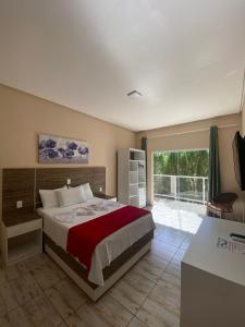 a bedroom with a large bed and a large window at Hotel São Francisco in Piranhas +64 photos