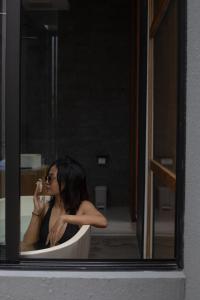 a woman sitting in a tub talking on a cell phone at Anasera Villas Echo Beach Canggu in Canggu