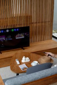 a living room with a coffee table and a tv at Anasera Villas Echo Beach Canggu in Canggu