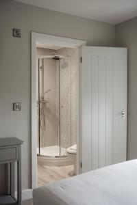 a bedroom with a bathroom with a shower and a toilet at Salt Rooms in Scarborough