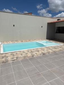 a swimming pool in front of a building at Casa Dunas douradas in Barreirinhas