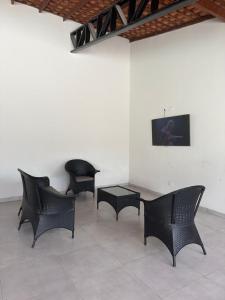 a group of chairs and a table in a room at Casa Dunas douradas in Barreirinhas