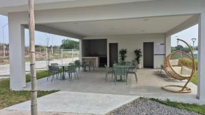a patio with a table and chairs and a basket at Your Perfect Rest Apartment with Pool and AC in Playa de Vacas