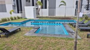 a swimming pool with two chairs at Your Perfect Rest Apartment with Pool and AC in Playa de Vacas