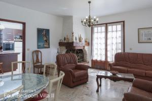 クアルテイラにあるAkivillas Quarteira Roseのリビングルーム(ソファ、椅子、テーブル付)