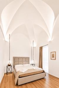 a bedroom with a large bed in a white room at Dimore Sangiuliano in Catania +174 photos