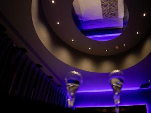a stage with purple lights and a mirror at FUN3 ﾌｧﾝｽﾘｰ -Adult Only- in Yokohama +123 photos