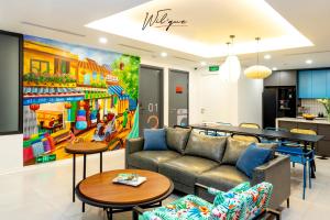 a living room with a couch and a table at Wilque Hotel Hanoi in Hanoi