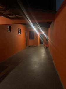 an empty hallway with a beam of light in a building at Hostel e Camping Terapia Roots in Santa Teresinha +1 photo