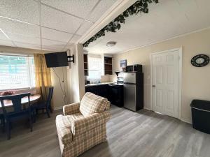a living room with a couch and a table and a kitchen at Crosswinds Motel in Old Orchard Beach