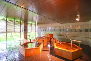 a large room with two hot tubs in the middle at Ooedo Onsen Monogatari Premium Kinugawa Kanko Hotel in Nikko