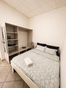 a white bedroom with a large bed and a refrigerator at CasaLoca Cabarete Studio Apartment in Cabarete +10 photos