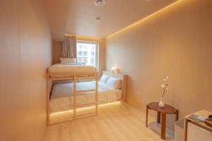 a small room with a bunk bed and a window at yulstay in Seoul