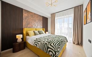 a bedroom with a black and white bed and a window at Barberry Apartments in Raadi