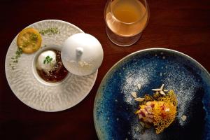 a table with two plates of food and a drink at KÚON Hakone Gora in Hakone