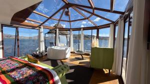 a room with a view of the water at TiticacaMarkaLodge in Puno