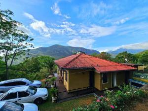 a small house with cars parked in front of it at Riverston Hideaway in Matale