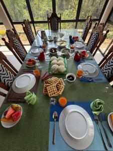 a long table with plates and food on it at Riverston Hideaway in Matale